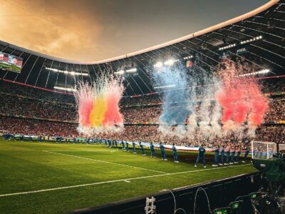 A stadium filled with lots of people watching a soccer game
